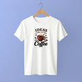 White t-shirt with coffee-themed graphic and text on a hanger against a purple background